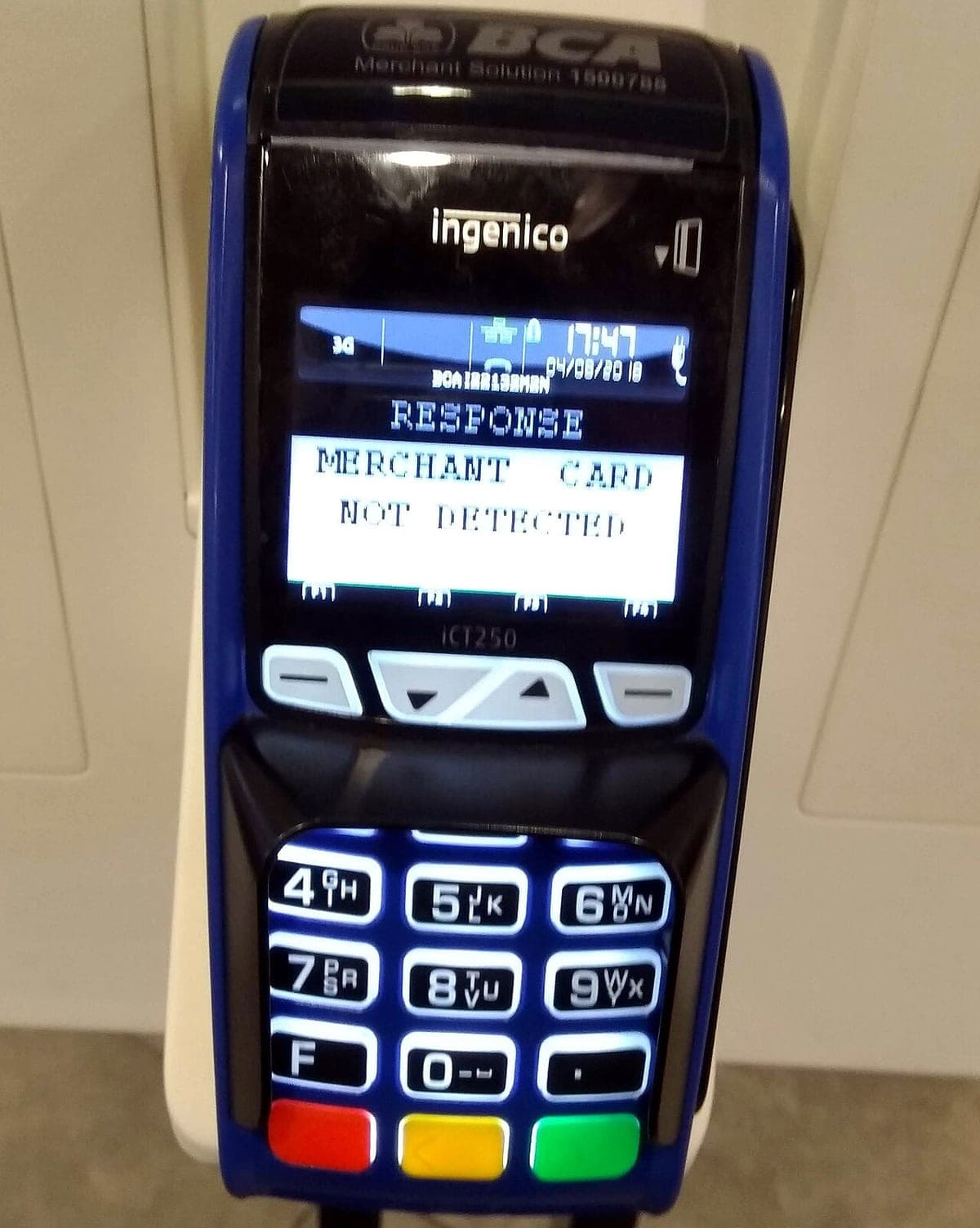 A card payment terminal on a counter, part of a networked point-of-sale installation